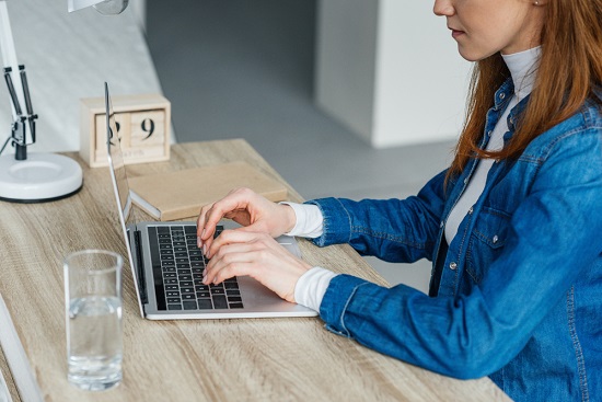 Woman typing on a computer