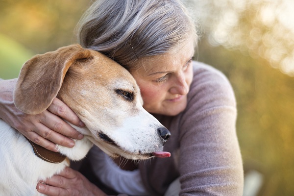 Woman hugging a disabled dog